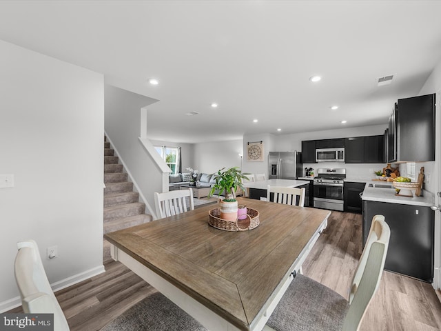 dining area with dark hardwood / wood-style floors and sink