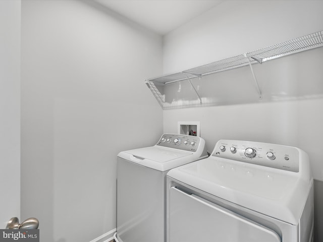 clothes washing area with independent washer and dryer