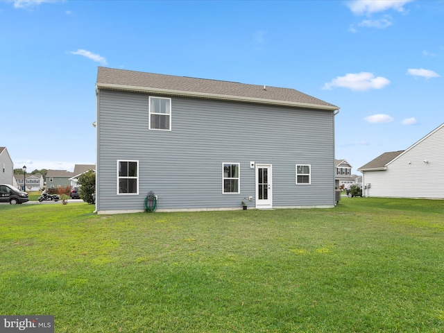 back of house featuring a yard