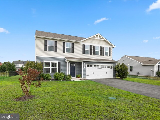 front of property featuring a garage and a front lawn