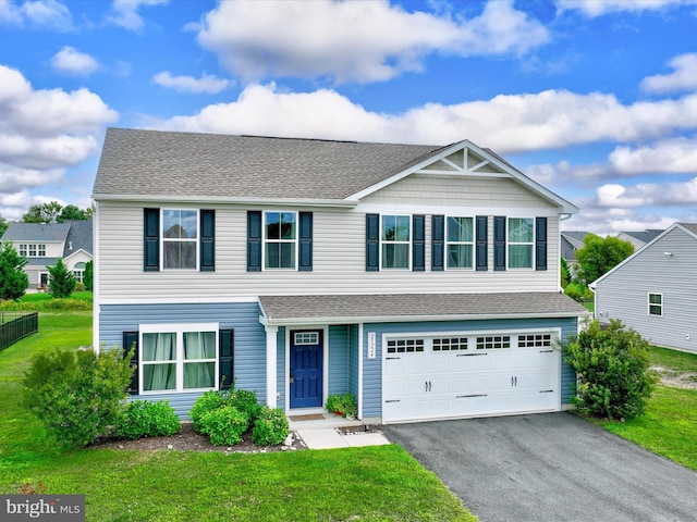 view of front of property featuring a garage and a front lawn