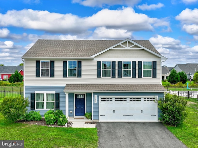 view of front of property featuring a garage and a front lawn