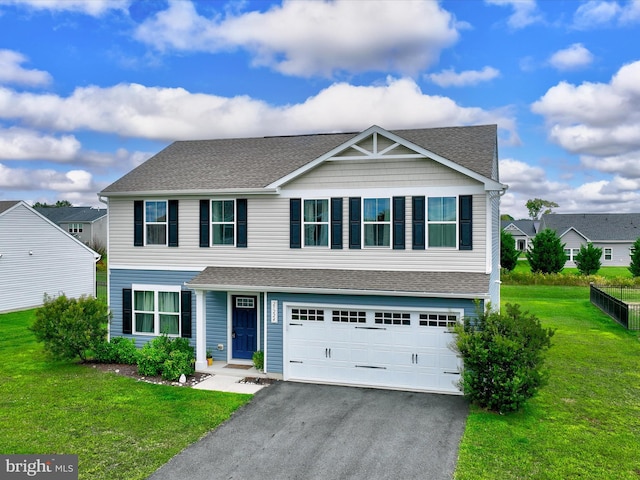 view of front of property featuring a front lawn and a garage