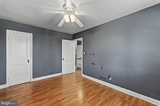 empty room with light hardwood / wood-style floors and ceiling fan