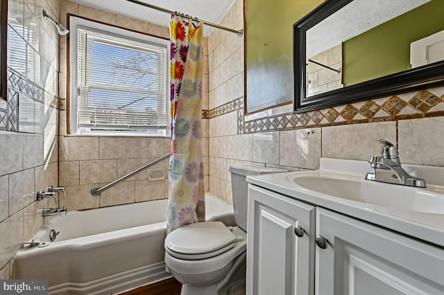 full bathroom featuring shower / tub combo with curtain, vanity, tile walls, and toilet