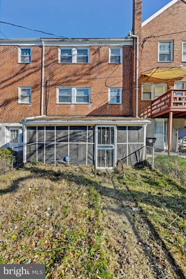 rear view of house with a sunroom