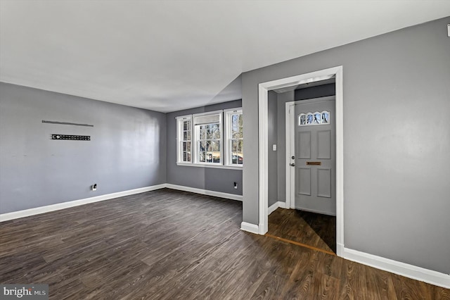 unfurnished room featuring dark hardwood / wood-style flooring