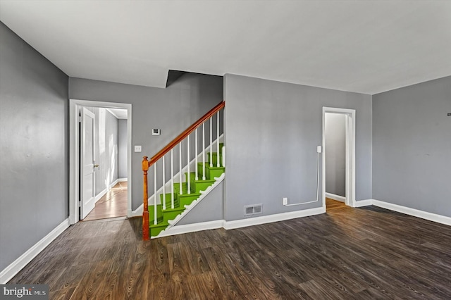 unfurnished room featuring dark hardwood / wood-style flooring