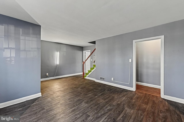 unfurnished room with dark hardwood / wood-style flooring