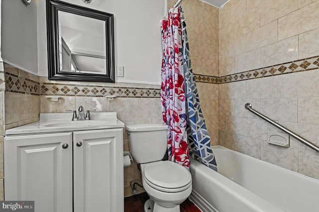 full bathroom with vanity, toilet, tile walls, and shower / tub combo with curtain