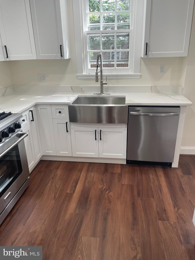 kitchen featuring white cabinets, stainless steel appliances, dark hardwood / wood-style floors, and sink