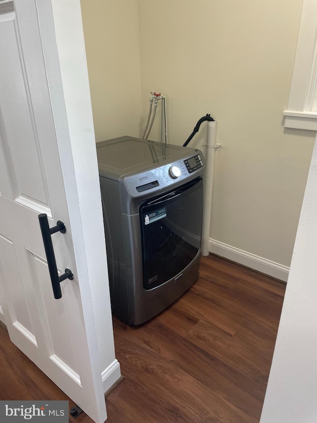 laundry area featuring washer / clothes dryer and dark wood-type flooring