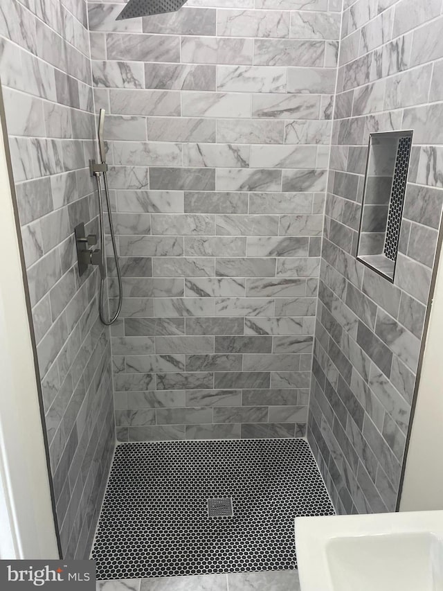 bathroom with a tile shower