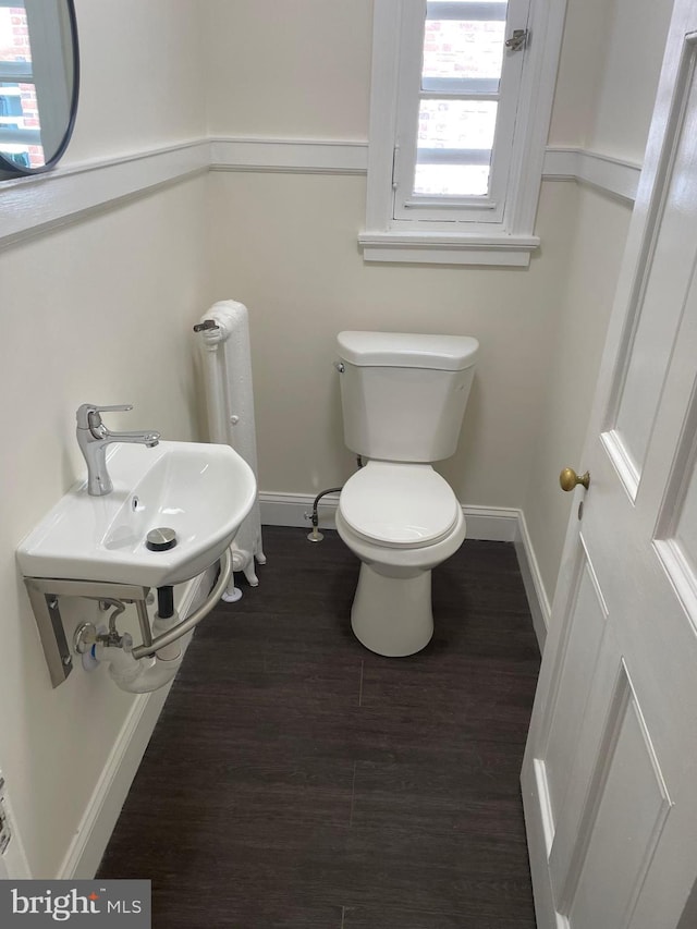 bathroom with toilet, hardwood / wood-style floors, and plenty of natural light