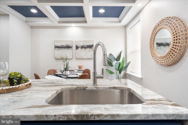 room details featuring beamed ceiling, sink, coffered ceiling, crown molding, and light stone countertops