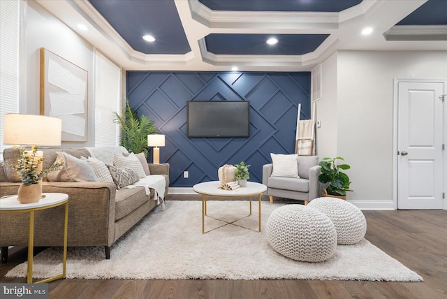 living room with coffered ceiling, a fireplace, ornamental molding, and dark wood-type flooring