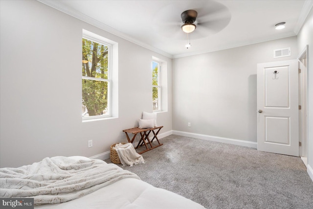 carpeted bedroom with ceiling fan and crown molding