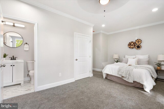 carpeted bedroom with sink, ceiling fan, ensuite bathroom, and crown molding