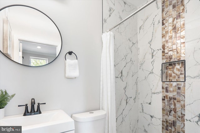 bathroom featuring toilet, walk in shower, and sink