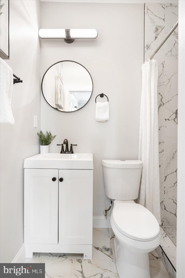 bathroom featuring walk in shower, vanity, and toilet