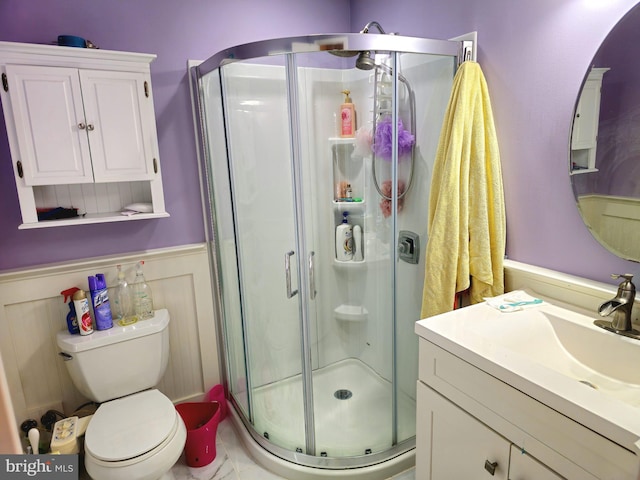 bathroom with vanity, toilet, and walk in shower