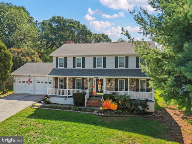 view of front of house featuring covered porch, a front yard, and a garage