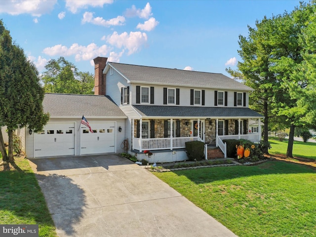 colonial home featuring a front yard, a garage, and a porch