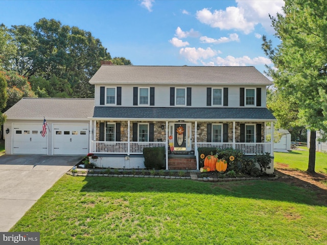 view of front facade featuring a front yard, a garage, and a porch