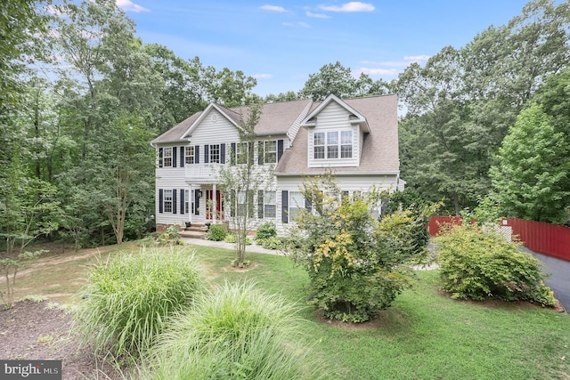 colonial home with a front lawn