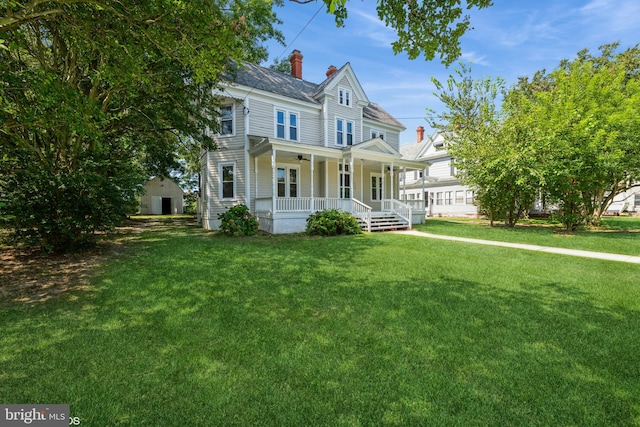 victorian home with a porch and a front yard