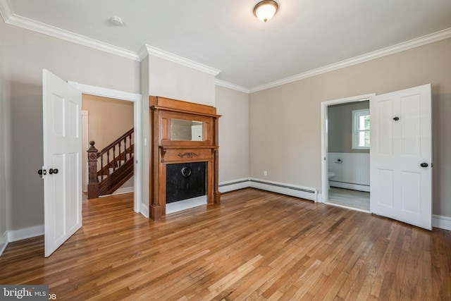 unfurnished living room with wood-type flooring, baseboard heating, and ornamental molding