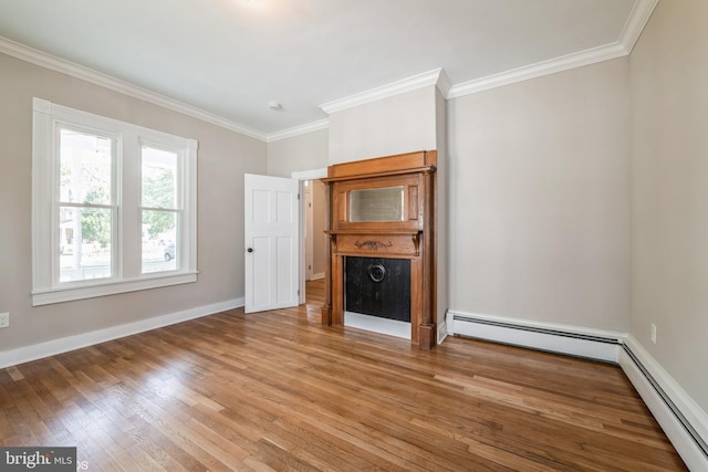 unfurnished living room featuring crown molding, a baseboard heating unit, and hardwood / wood-style floors