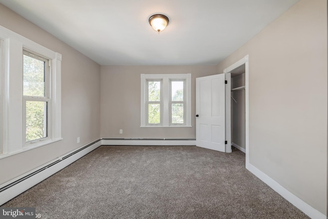 unfurnished bedroom featuring carpet flooring and a baseboard radiator