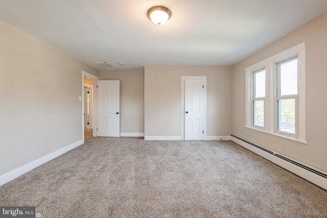 unfurnished bedroom with carpet flooring and a baseboard radiator