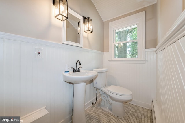 bathroom featuring toilet, tile patterned floors, and vaulted ceiling