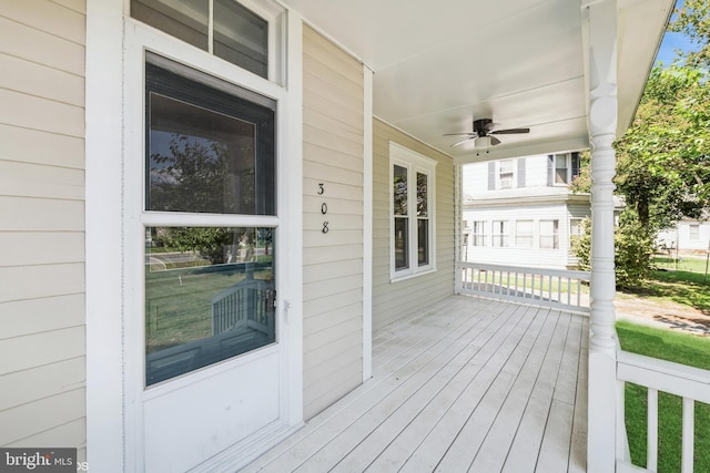 wooden deck with ceiling fan and a porch