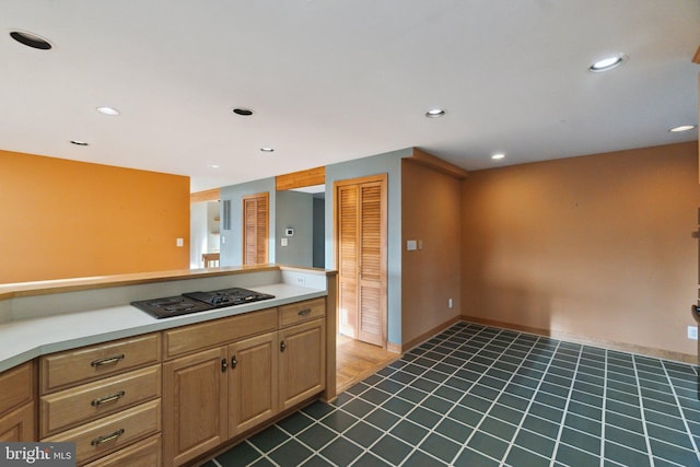 kitchen featuring black gas stovetop and dark tile patterned floors