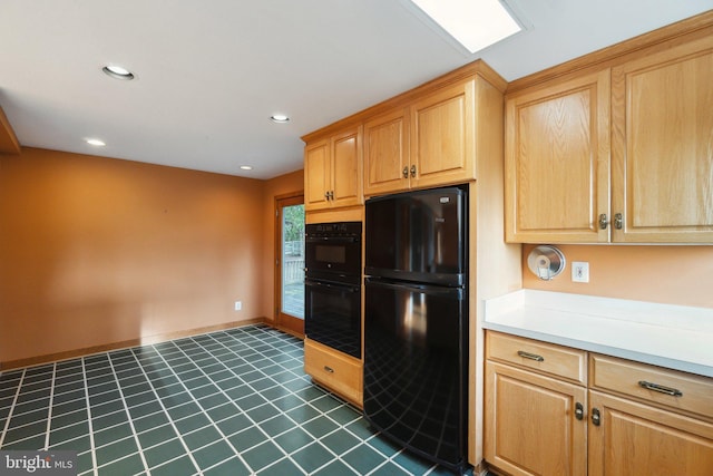 kitchen with black appliances and dark tile patterned flooring