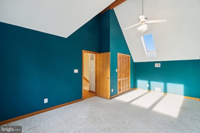 bonus room with ceiling fan, high vaulted ceiling, a skylight, and carpet floors