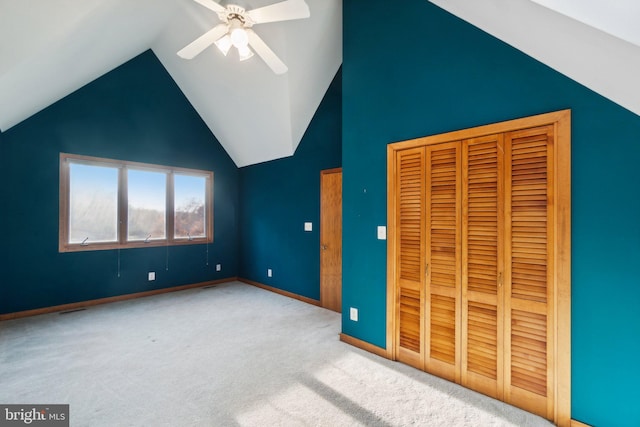 unfurnished bedroom with vaulted ceiling, light colored carpet, and ceiling fan