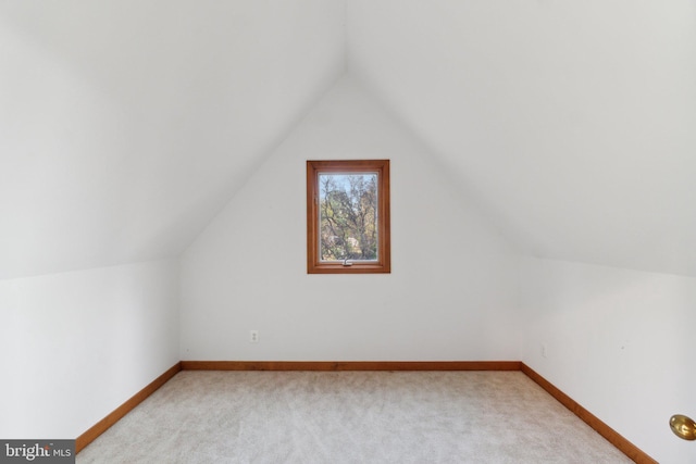 bonus room featuring light carpet and vaulted ceiling