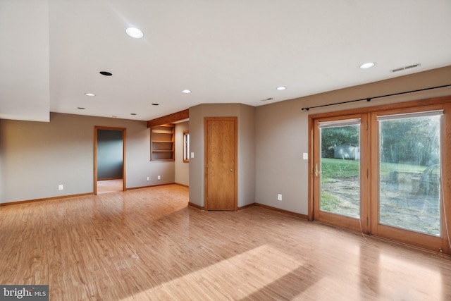 unfurnished living room with light wood-type flooring