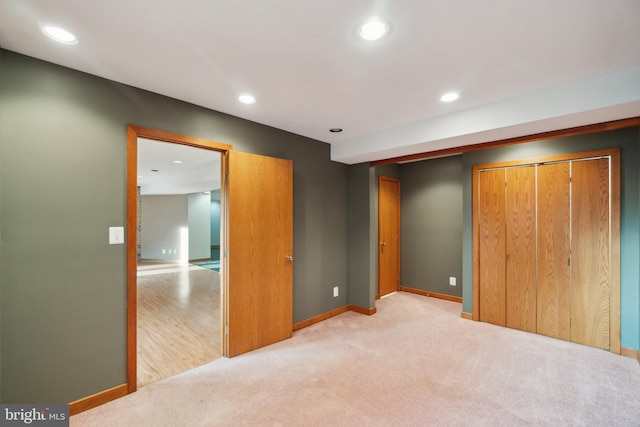 bedroom featuring a closet and light colored carpet