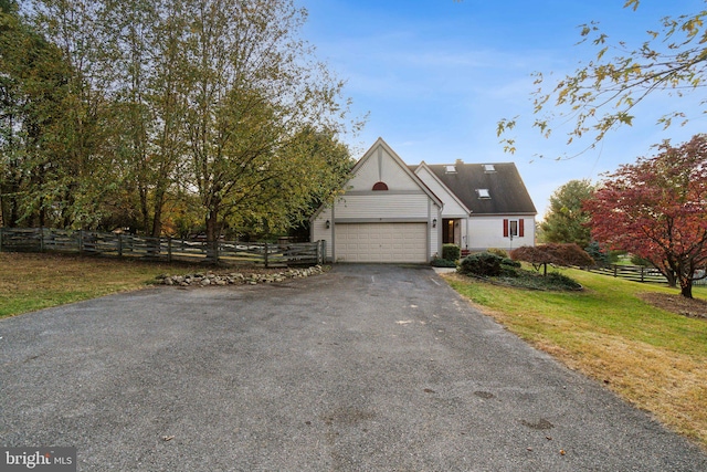 view of front facade featuring a garage and a front lawn