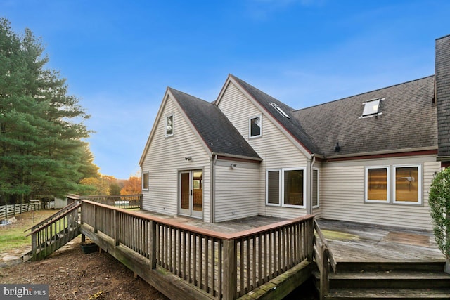 rear view of property featuring a deck