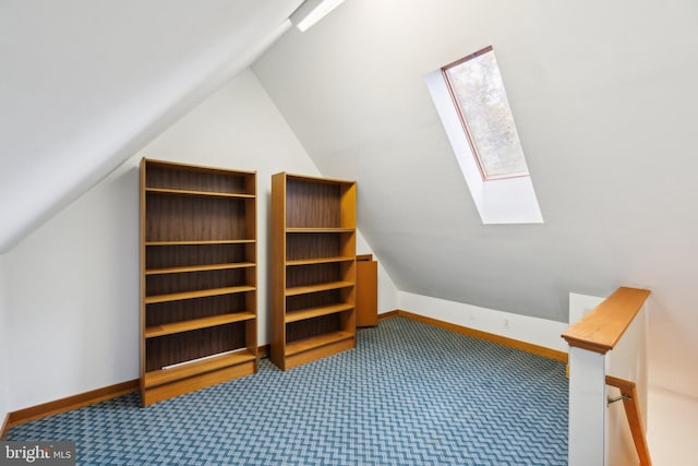 additional living space with carpet and vaulted ceiling with skylight