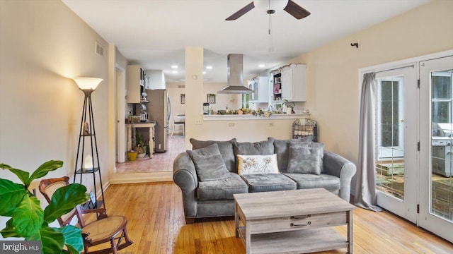 living room featuring light wood-type flooring and ceiling fan