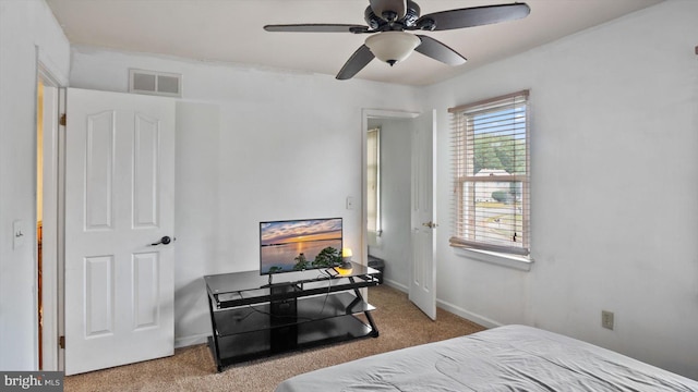 bedroom with ceiling fan and light colored carpet