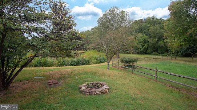 view of yard featuring an outdoor fire pit