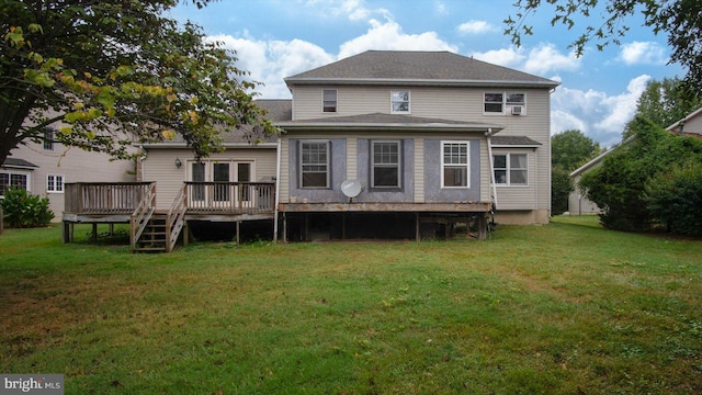 rear view of house featuring a wooden deck and a yard